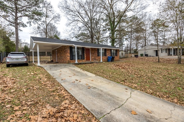 ranch-style house with a carport and a front yard