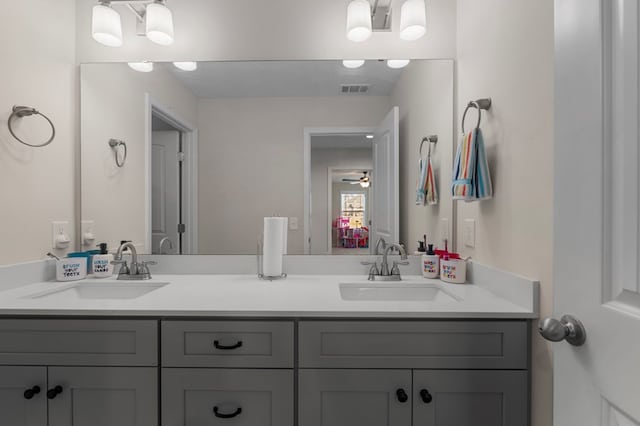 full bathroom featuring double vanity, ceiling fan, visible vents, and a sink