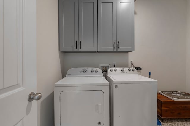 laundry area featuring cabinet space and washing machine and clothes dryer