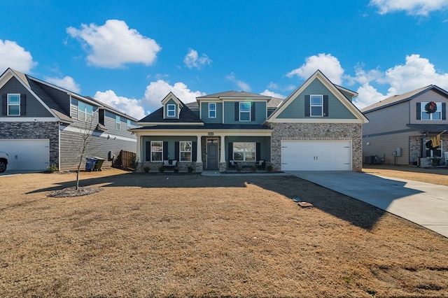 craftsman house with an attached garage, driveway, and a front lawn