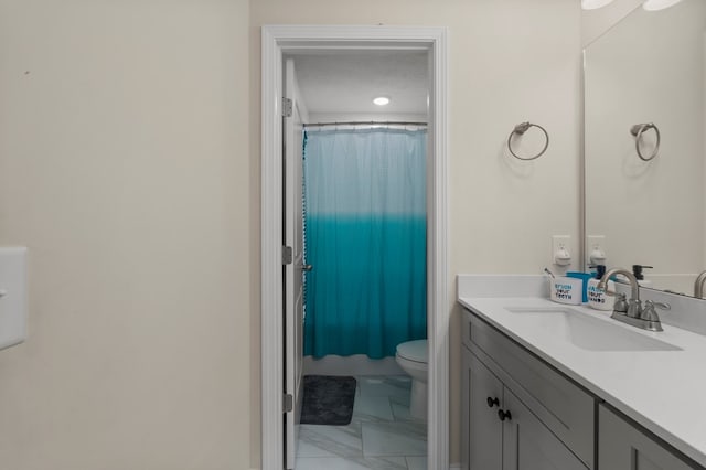 full bathroom featuring a textured ceiling, toilet, a shower with shower curtain, vanity, and marble finish floor