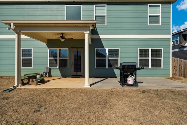 rear view of property featuring a yard, a patio, fence, and ceiling fan