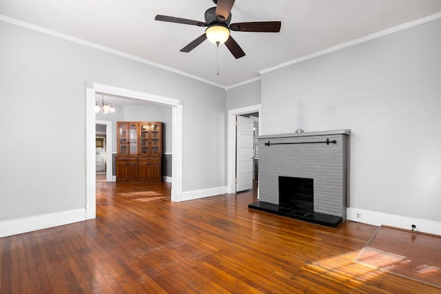 1024 18th St, Columbus, GA 31901 - unfurnished living room featuring hardwood / wood-style floors, a brick fireplace, crown molding, a ceiling fan, and a chandelier