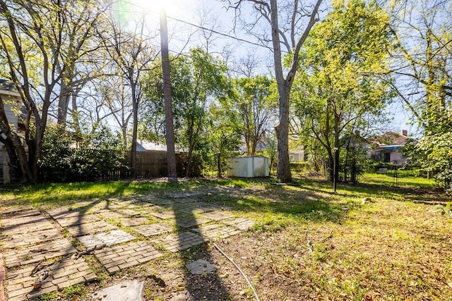 1024 18th St, Columbus, GA 31901 - fenced backyard with a storage unit and a patio