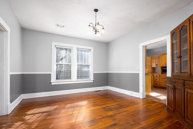 1024 18th St, Columbus, GA 31901 - unfurnished room with wood-type flooring, a chandelier, and a wainscoted wall