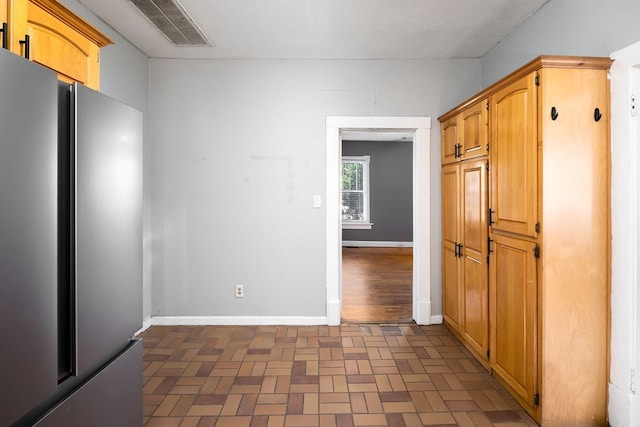 1024 18th St, Columbus, GA 31901 - kitchen featuring freestanding refrigerator and brick patterned floors