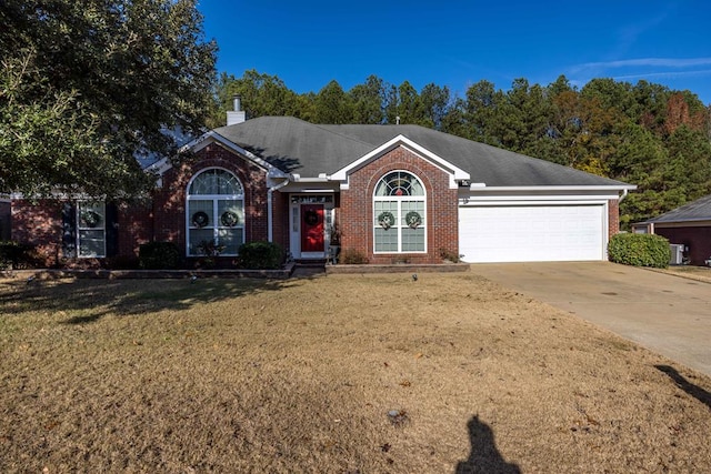 ranch-style house with a garage and a front lawn