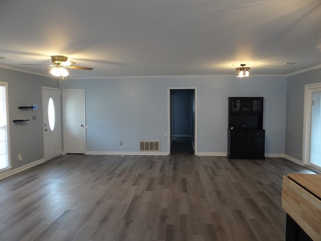 unfurnished living room with visible vents, baseboards, ornamental molding, wood finished floors, and a ceiling fan