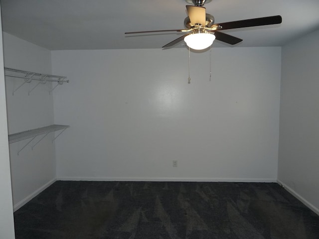 carpeted empty room featuring baseboards