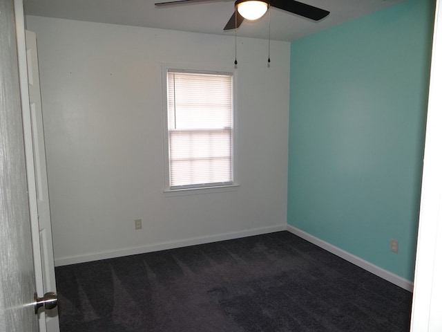 unfurnished room featuring baseboards, ceiling fan, and dark carpet