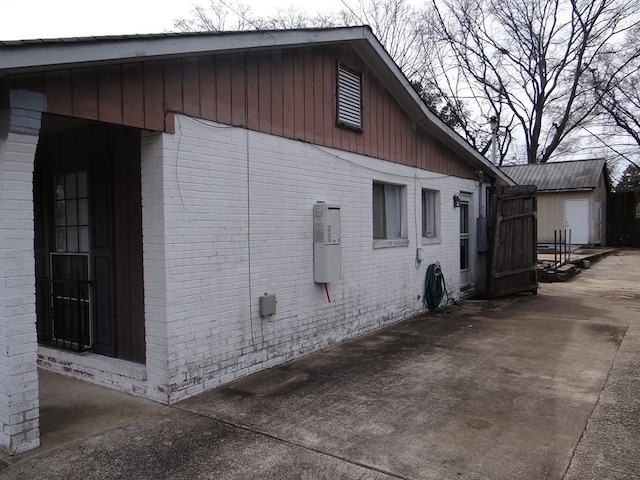 view of side of property featuring brick siding