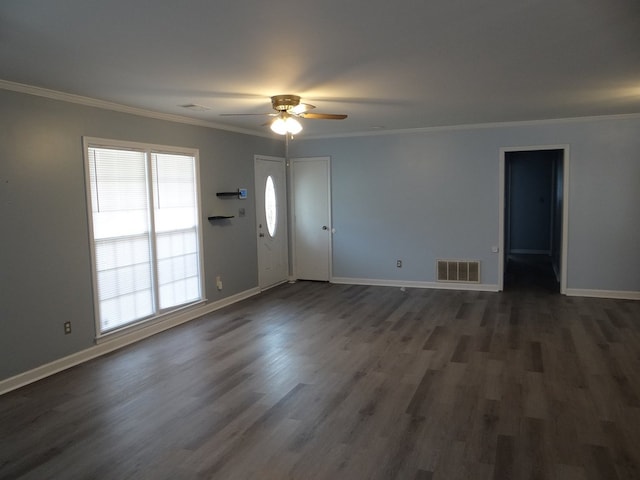 unfurnished living room with baseboards, visible vents, and ornamental molding