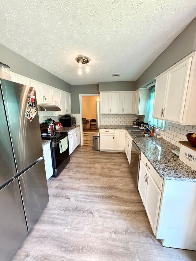 7340 Village Loop, Columbus, GA 31904 - kitchen with white cabinetry, stainless steel appliances, decorative backsplash, and under cabinet range hood
