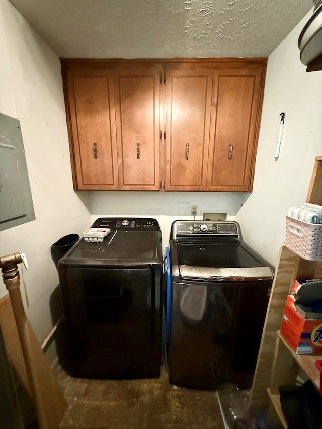 laundry area with washing machine and dryer, cabinet space, and electric panel