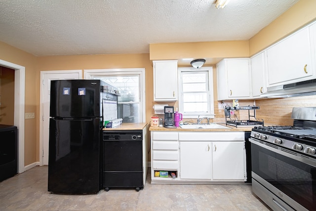 1043 Quincy Dr, Columbus, GA 31906 - kitchen with black appliances, under cabinet range hood, light countertops, white cabinetry, and a textured ceiling