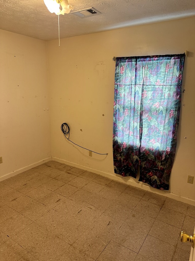 1103 52nd St, Columbus, GA 31904 - spare room featuring ceiling fan, a textured ceiling, and baseboards