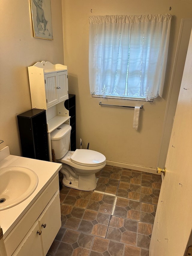 1103 52nd St, Columbus, GA 31904 - half bathroom with toilet, vanity, and stone finish floors