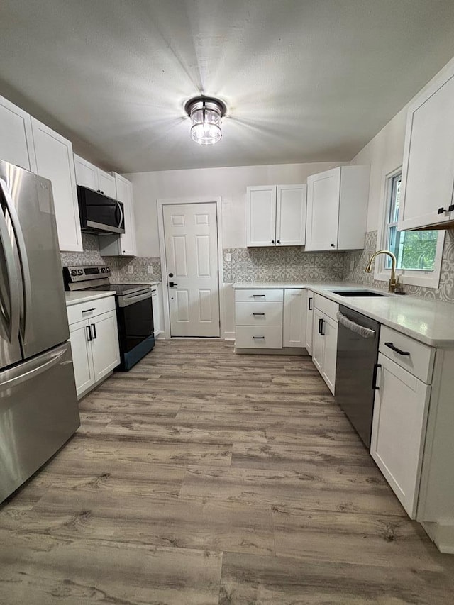 4026 Bowman St, Columbus, GA 31903 - kitchen featuring stainless steel appliances, white cabinetry, backsplash, and dark wood-style flooring