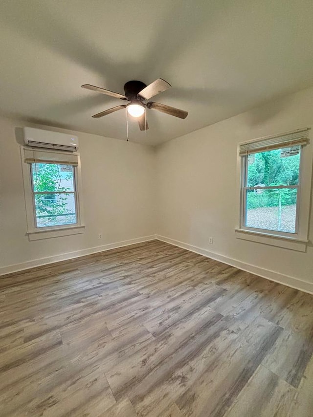 4026 Bowman St, Columbus, GA 31903 - unfurnished room featuring an AC wall unit, wood finished floors, and a ceiling fan