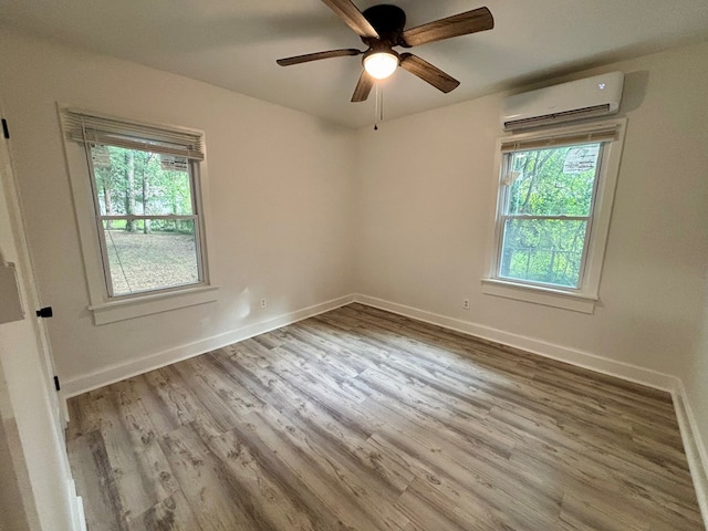 4026 Bowman St, Columbus, GA 31903 - spare room featuring a wall unit AC, wood finished floors, and ceiling fan