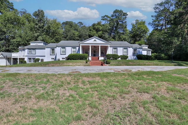 view of front of home with a porch and a front yard