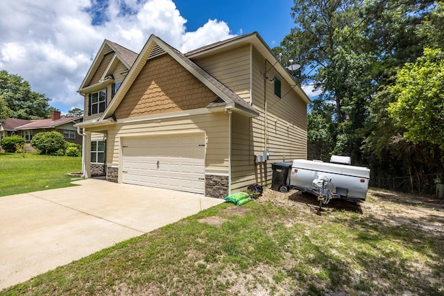1417 Cloverdale Rd, Columbus, GA 31904 - view of home's exterior with driveway, a lawn, stone siding, and an attached garage