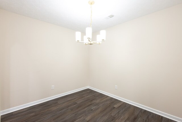 924 Vista Dr, Columbus, GA 31907 - unfurnished room with visible vents, baseboards, an inviting chandelier, and dark wood-type flooring