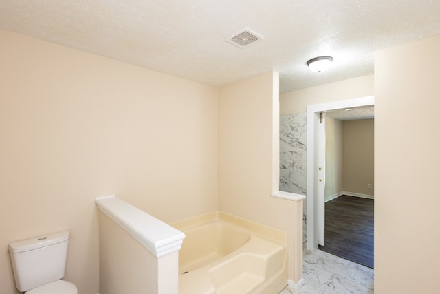 924 Vista Dr, Columbus, GA 31907 - full bathroom with a garden tub, a textured ceiling, marble finish floor, toilet, and visible vents