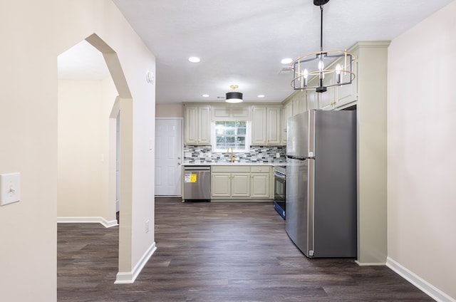 924 Vista Dr, Columbus, GA 31907 - kitchen featuring a sink, arched walkways, light countertops, appliances with stainless steel finishes, and dark wood-style floors
