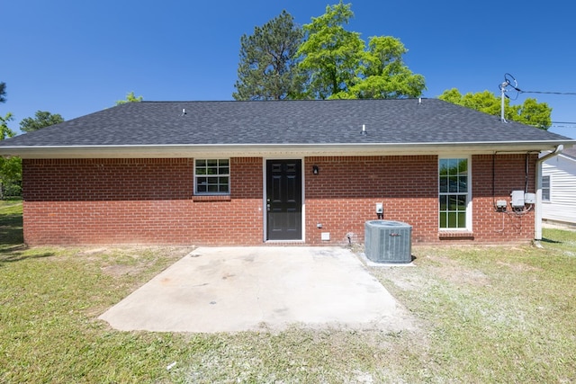 924 Vista Dr, Columbus, GA 31907 - rear view of property featuring a patio area, central air condition unit, a lawn, brick siding, and roof with shingles