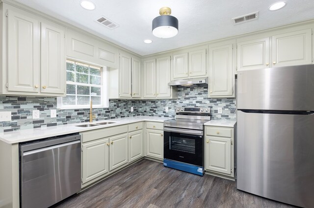 924 Vista Dr, Columbus, GA 31907 - kitchen featuring a sink, visible vents, light countertops, under cabinet range hood, and appliances with stainless steel finishes