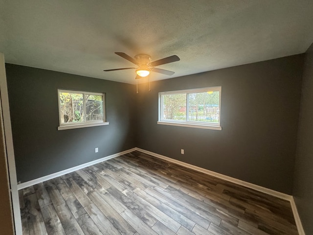 empty room with a textured ceiling, hardwood / wood-style flooring, and ceiling fan