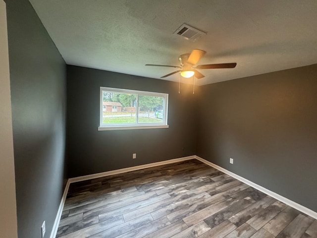 empty room with hardwood / wood-style floors, a textured ceiling, and ceiling fan