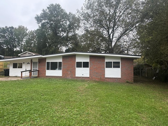 back of property featuring a lawn