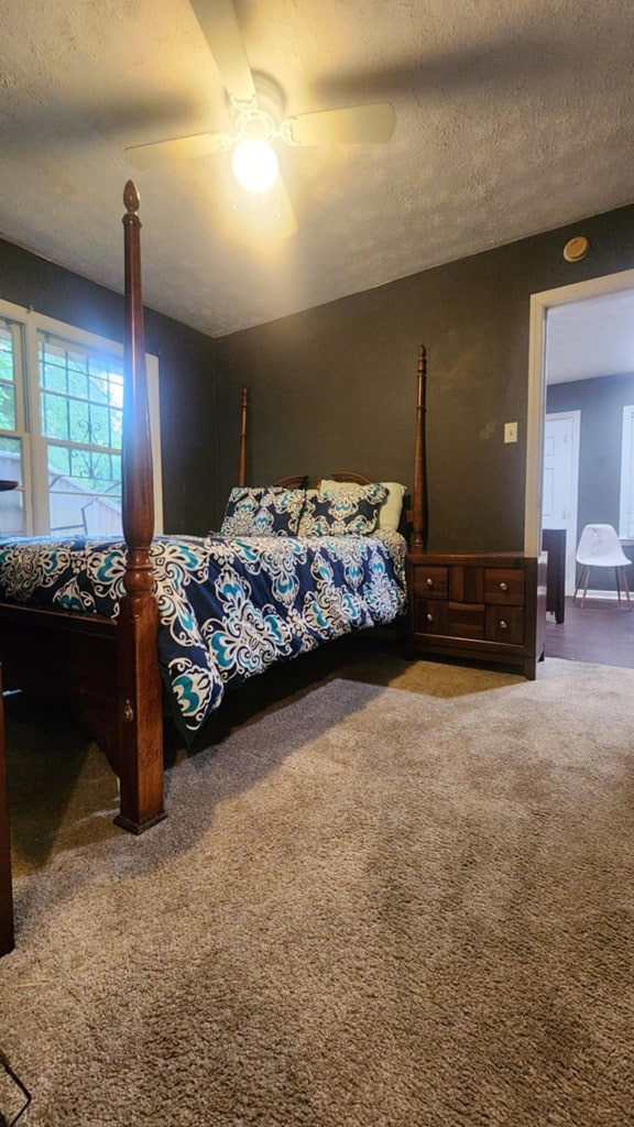 1434 John Smith Ave, Columbus, GA 31903 - carpeted bedroom with a textured ceiling and a ceiling fan