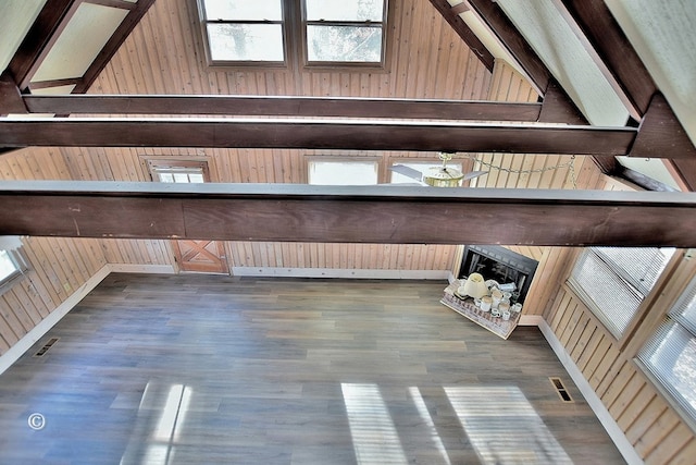 interior space with hardwood / wood-style floors and wood walls