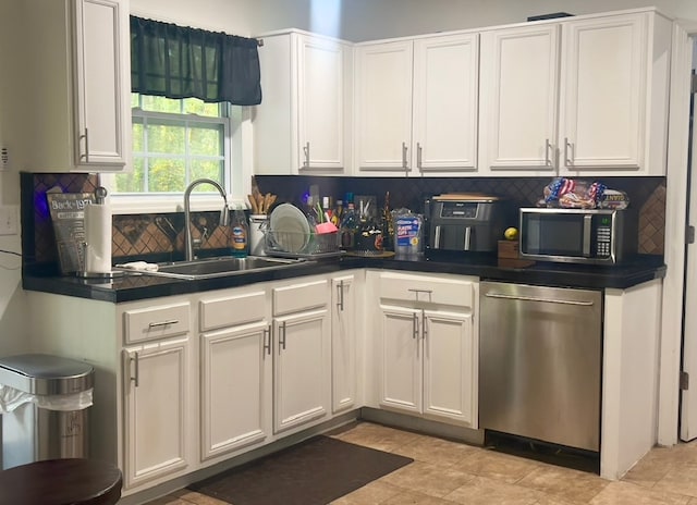 6840 Hidden Lake Dr, Rex, GA 30273 - kitchen featuring stainless steel appliances, decorative backsplash, white cabinetry, and dark countertops