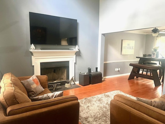 6840 Hidden Lake Dr, Rex, GA 30273 - living area with wood finished floors, a ceiling fan, and a fireplace with flush hearth