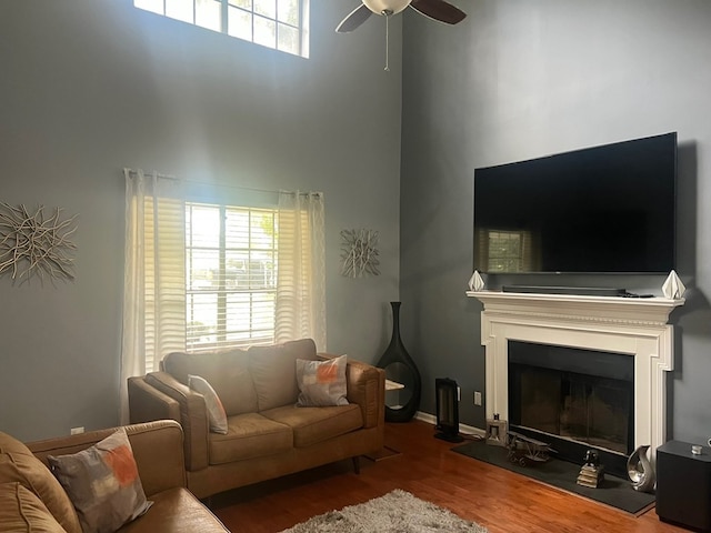 6840 Hidden Lake Dr, Rex, GA 30273 - living room with a high ceiling, wood finished floors, a ceiling fan, and a fireplace