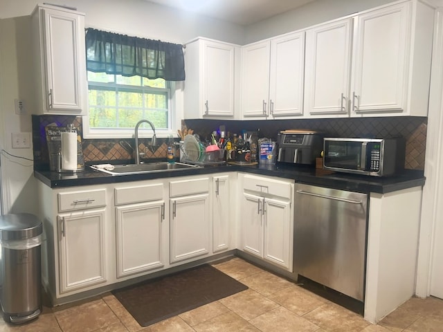 6840 Hidden Lake Dr, Rex, GA 30273 - kitchen featuring appliances with stainless steel finishes, backsplash, dark countertops, and white cabinets