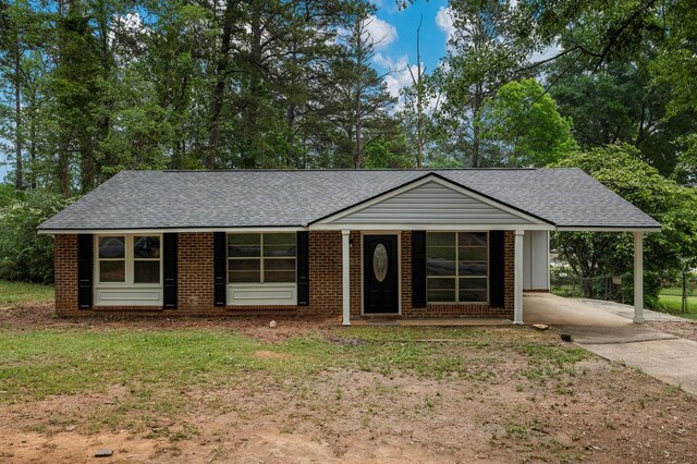 8344 Twin Chapel Dr, Columbus, GA 31904 - ranch-style house with concrete driveway, a shingled roof, an attached carport, and brick siding