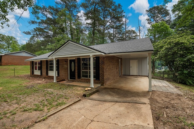 8344 Twin Chapel Dr, Columbus, GA 31904 - view of front facade with a porch, an attached carport, brick siding, roof with shingles, and concrete driveway