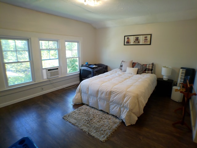 bedroom featuring lofted ceiling, cooling unit, and dark hardwood / wood-style floors