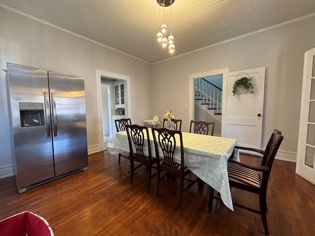 dining space with a notable chandelier, ornamental molding, and dark wood-type flooring