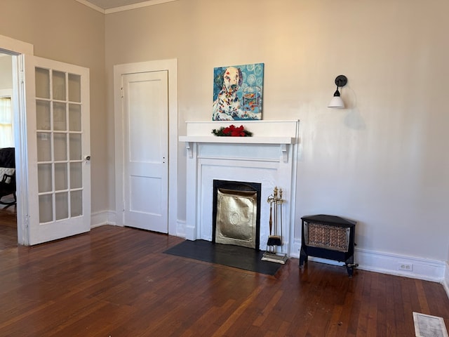 living room with dark hardwood / wood-style flooring and ornamental molding