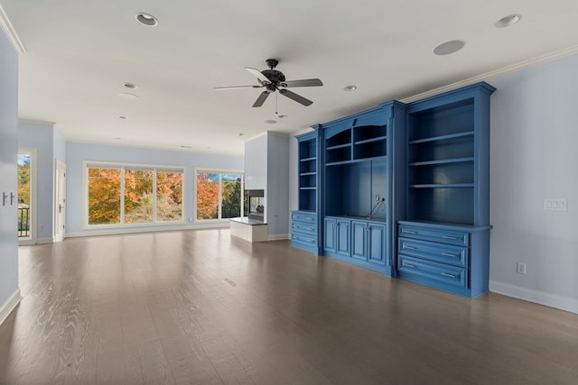 unfurnished living room with hardwood / wood-style floors, ceiling fan, built in shelves, and crown molding