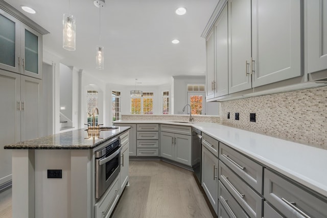 kitchen featuring stainless steel appliances, sink, and gray cabinets