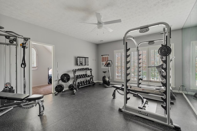 exercise room featuring a textured ceiling and ceiling fan