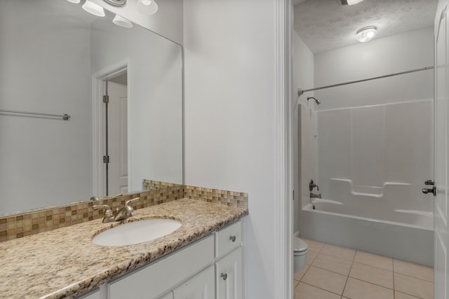 full bathroom with a textured ceiling, tile patterned flooring, tub / shower combination, toilet, and decorative backsplash