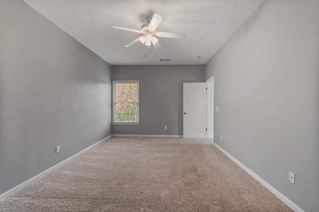 carpeted empty room featuring a textured ceiling and ceiling fan